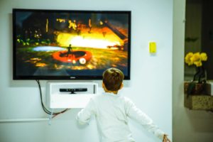 a child enjoying one of the best buy tvs in his home